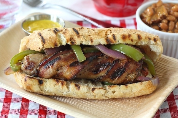 Grilled Bacon-Wrapped Bratwursts Topped With Peppers