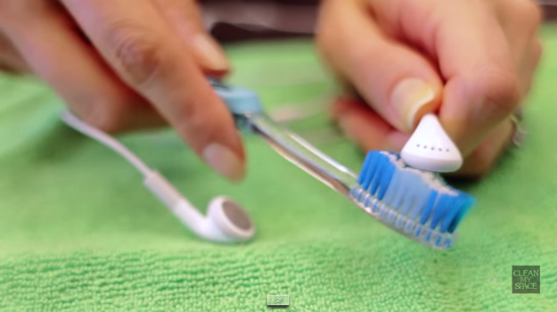 A toothbrush safely dislodges dirt from speaker mesh.