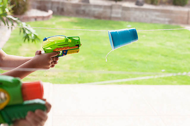 Use squirt guns to race plastic cups down a line.